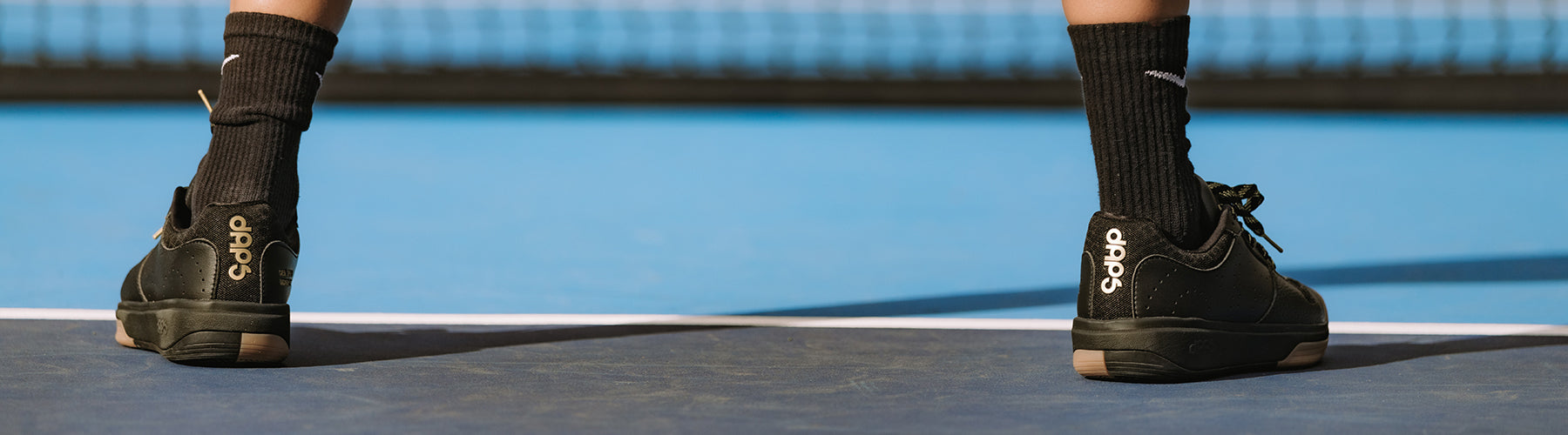 DAPS outdoor pickleball shoes on a hard court, built for traction and durability on concrete and asphalt surfaces
