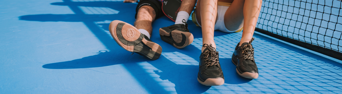 Two players resting in pickleball court shoes