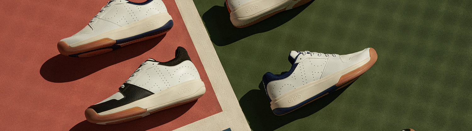 DAPS Desi Low pickleball shoes shown side by side on indoor hardwood and outdoor green court surfaces, highlighting versatility across both court types.
